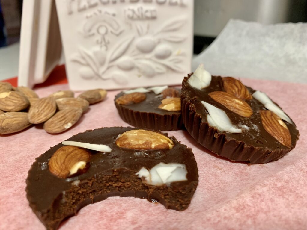 Paleo vegan gluten free fudge cups with almond and coconut flakes